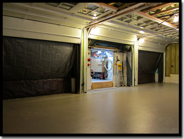 Interior view of a Twin Cities garage during Concrete Renewal's Step 1 climate control setup, showing the proprietary trailer connected to the workspace to manage humidity and air temperature for a perfect Poly-Quartz floor coating bond.
